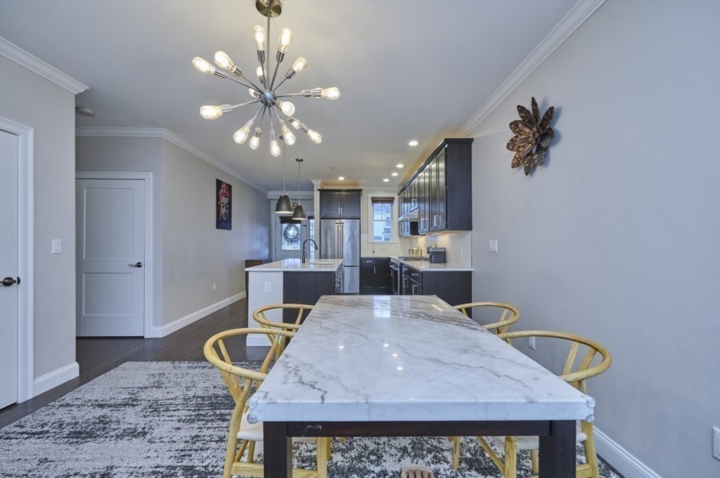 299 Lexington Street, Unit 51 Woburn, MA 01801 - Photo 5 of 37 a kitchen with a table and chairs in it