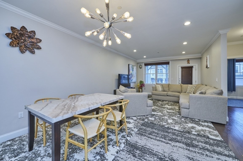 299 Lexington Street, Unit 51 Woburn, MA 01801 - Photo 6 of 37 a living room with furniture and a chandelier