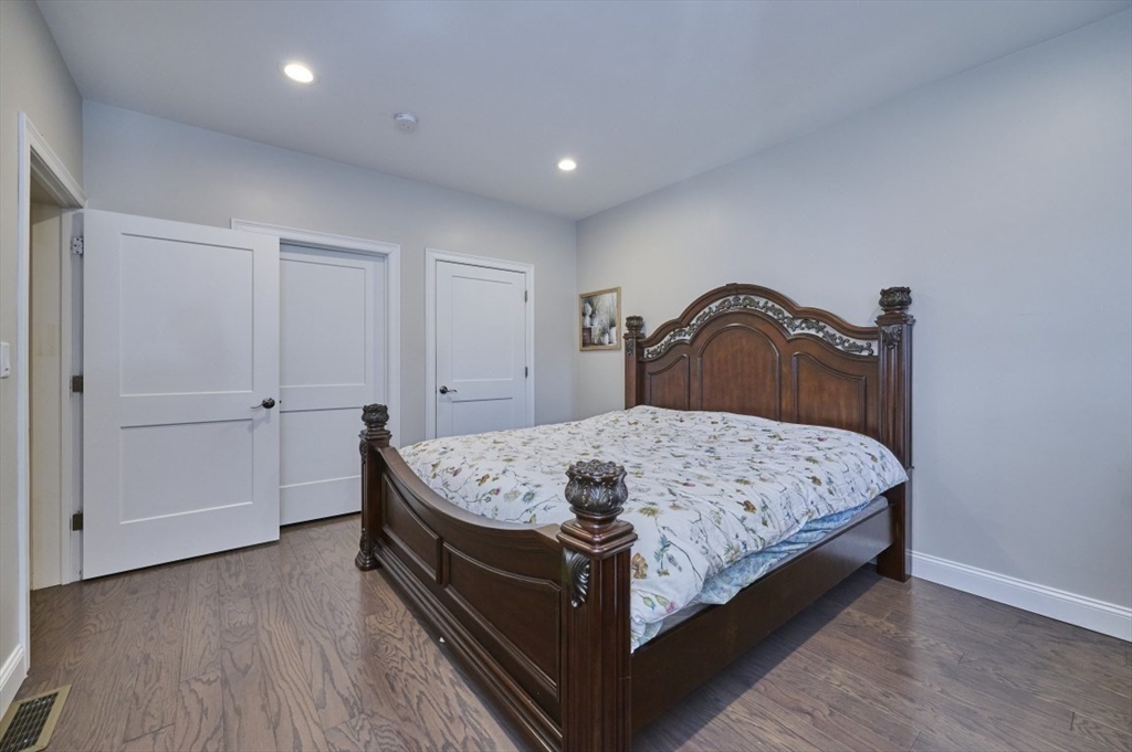 299 Lexington Street, Unit 51 Woburn, MA 01801 - Photo 9 of 37 a bedroom with a bed and a dresser