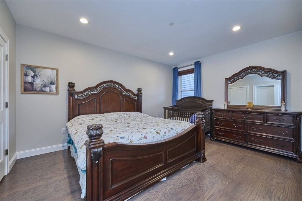 299 Lexington Street, Unit 51 Woburn, MA 01801 - Photo 10 of 37 a bedroom with a bed and a dresser