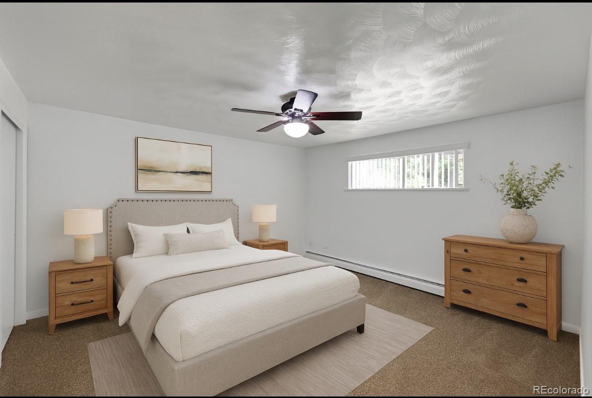 3709 Allison Street Wheat Ridge, CO 80033 - Photo 16 of 44 a bedroom with a bed and a chandelier