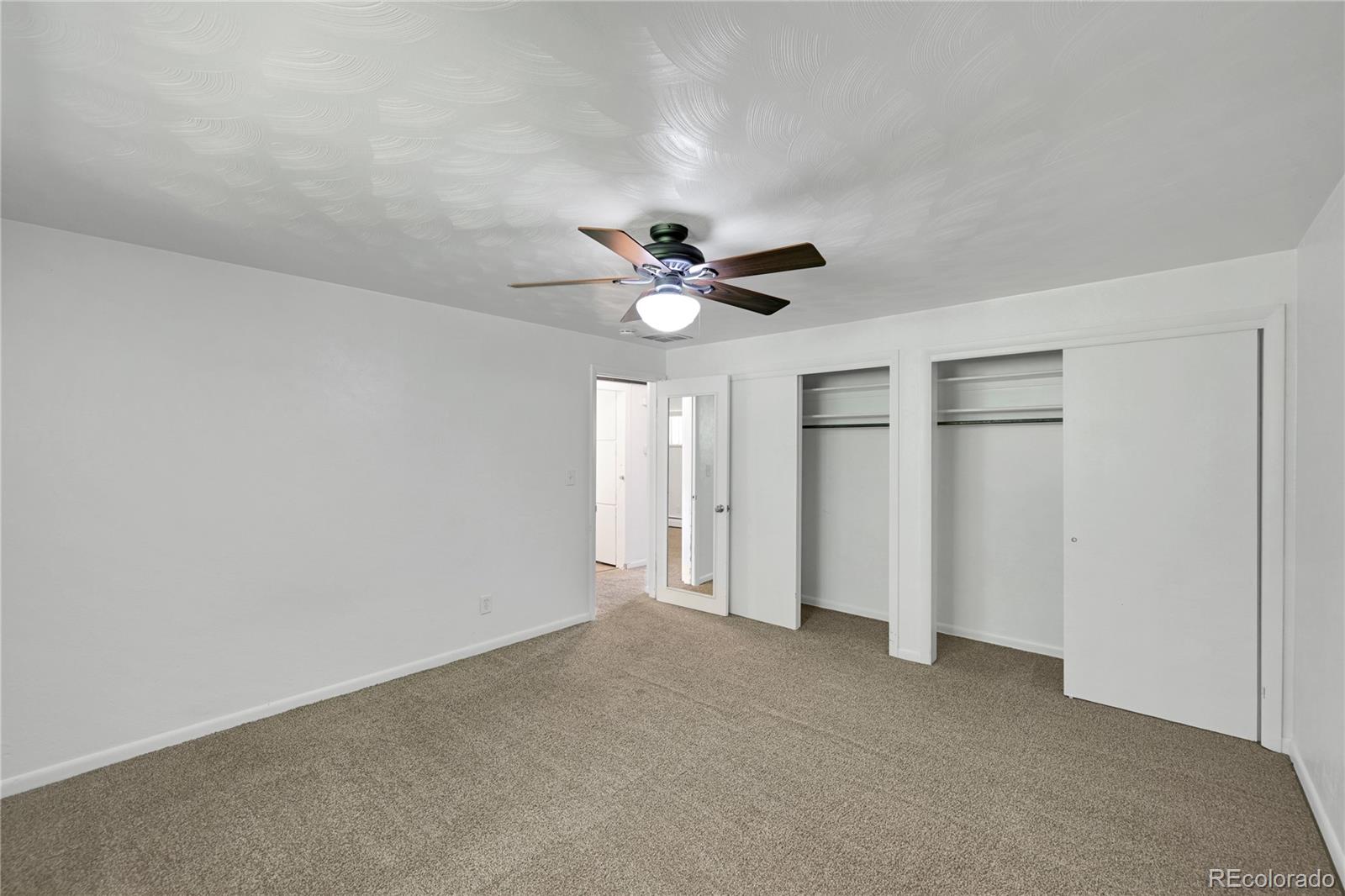 3709 Allison Street Wheat Ridge, CO 80033 - Photo 17 of 44 a view of an empty room with a ceiling fan