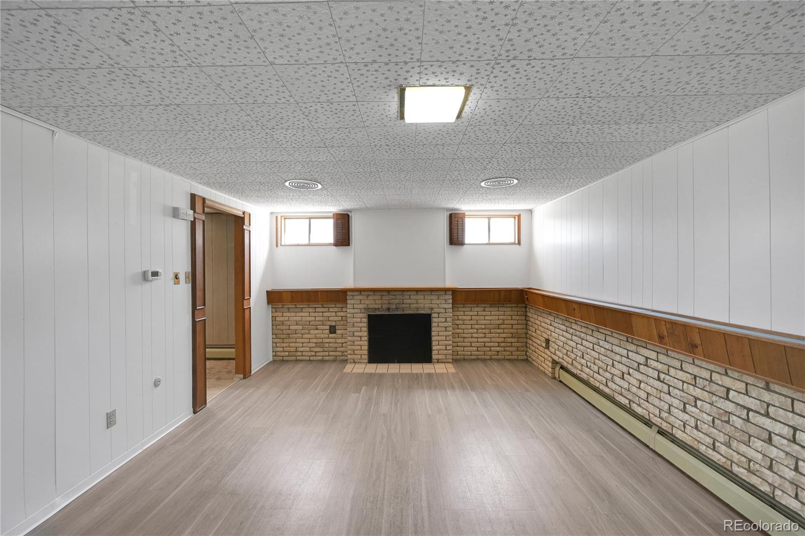 3709 Allison Street Wheat Ridge, CO 80033 - Photo 20 of 44 a view of an empty room with wooden floor and a window
