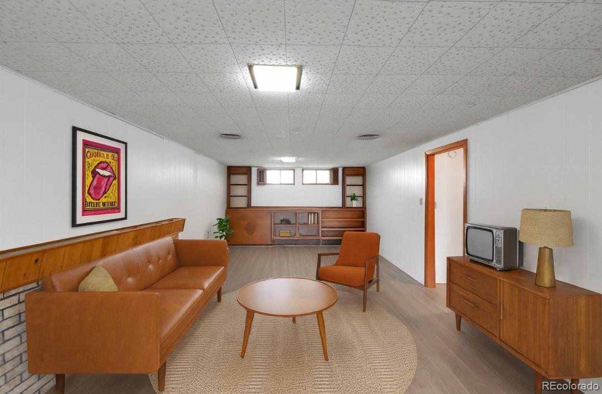 3709 Allison Street Wheat Ridge, CO 80033 - Photo 22 of 44 a living room with furniture and a flat screen tv