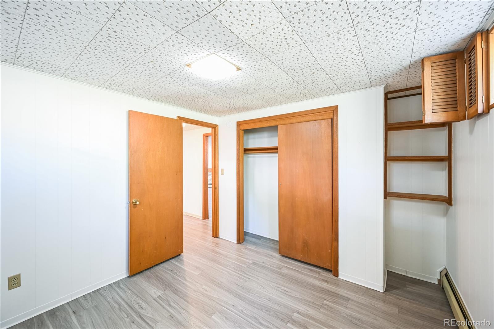3709 Allison Street Wheat Ridge, CO 80033 - Photo 25 of 44 an empty room with wooden floor and windows
