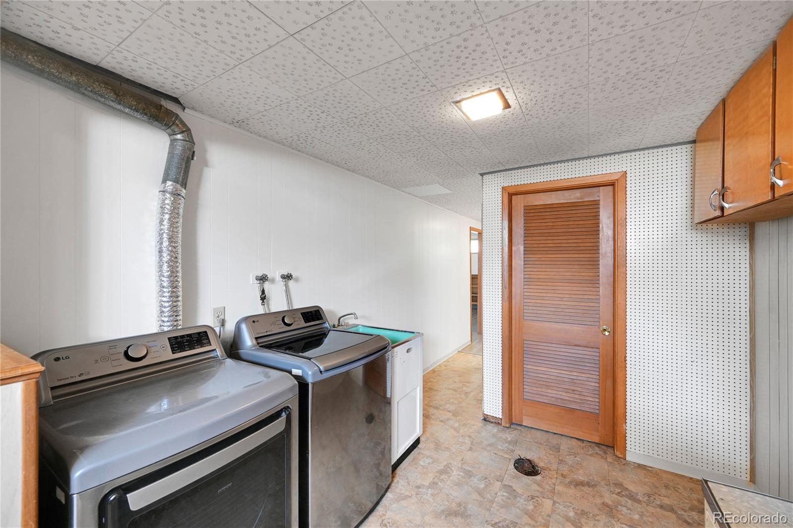 3709 Allison Street Wheat Ridge, CO 80033 - Photo 27 of 44 a kitchen that has a sink and a stove