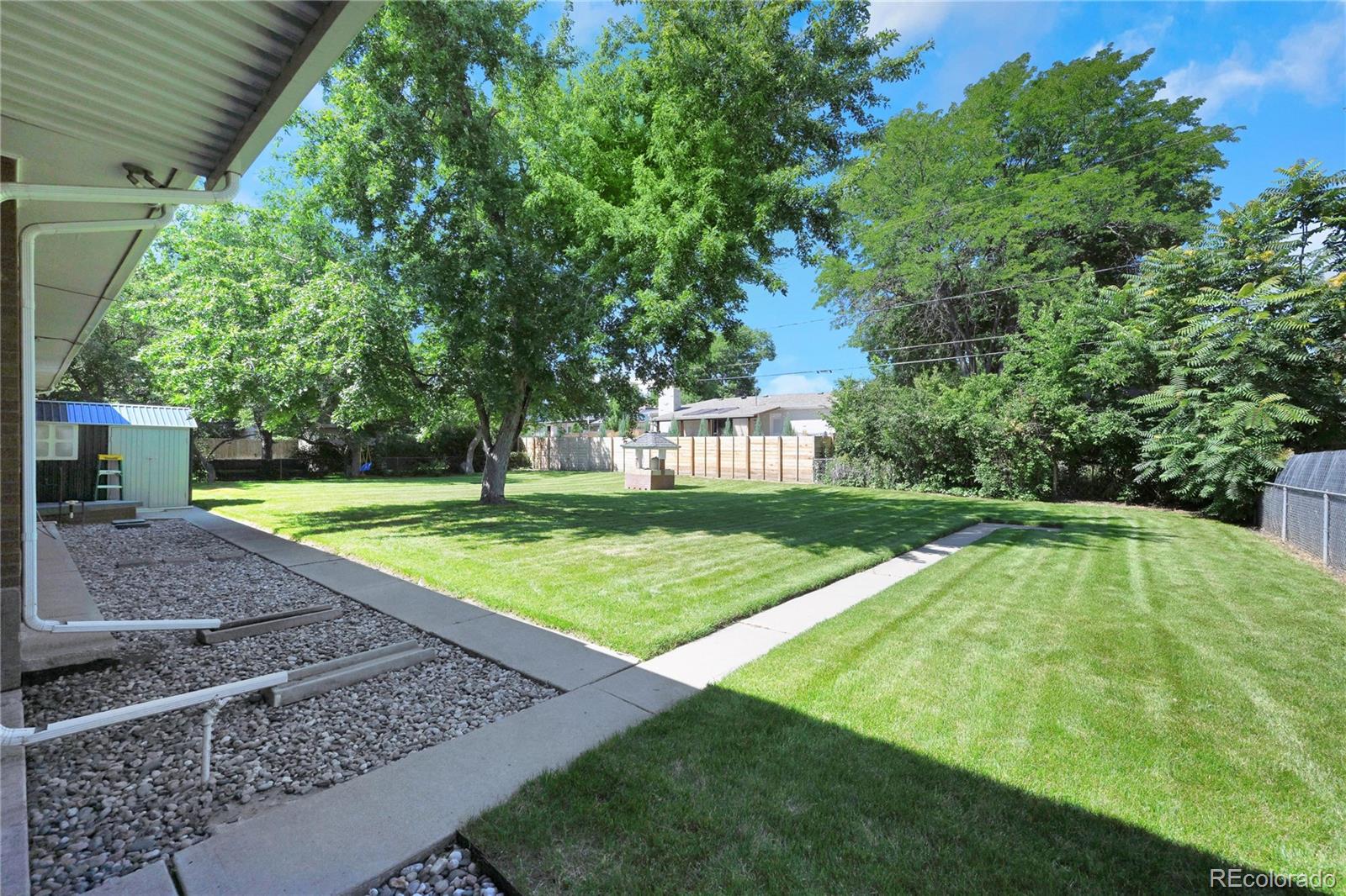 3709 Allison Street Wheat Ridge, CO 80033 - Photo 29 of 44 a view of yard with swimming pool and garden