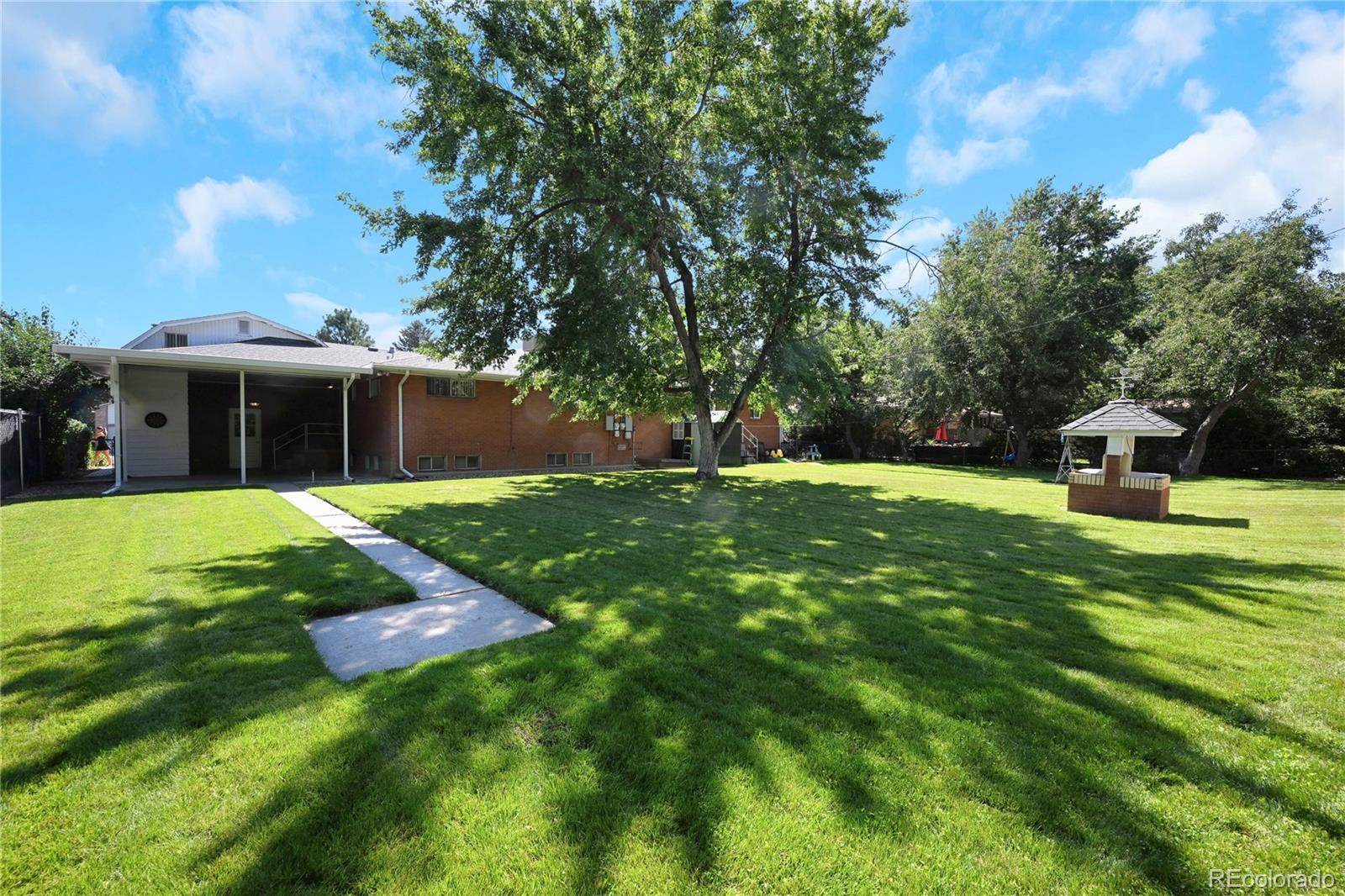 3709 Allison Street Wheat Ridge, CO 80033 - Photo 30 of 44 a view of a house with a yard porch and sitting area