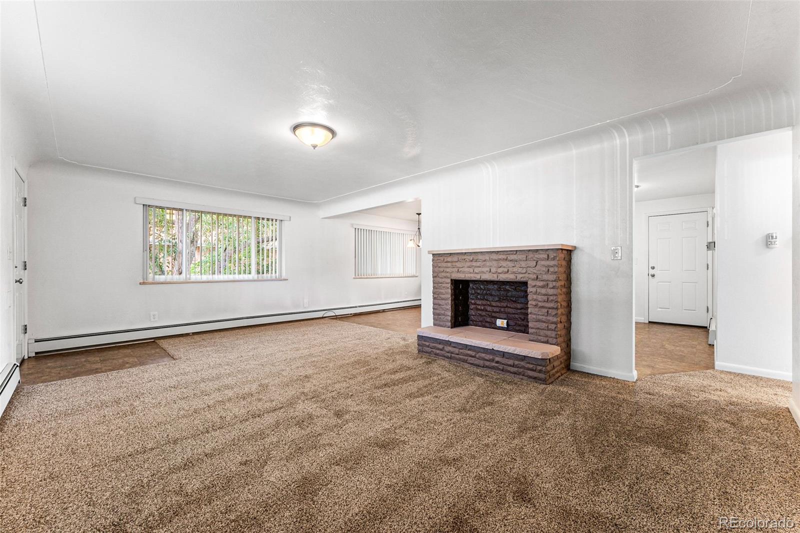 3709 Allison Street Wheat Ridge, CO 80033 - Photo 32 of 44 an empty room with windows and fireplace