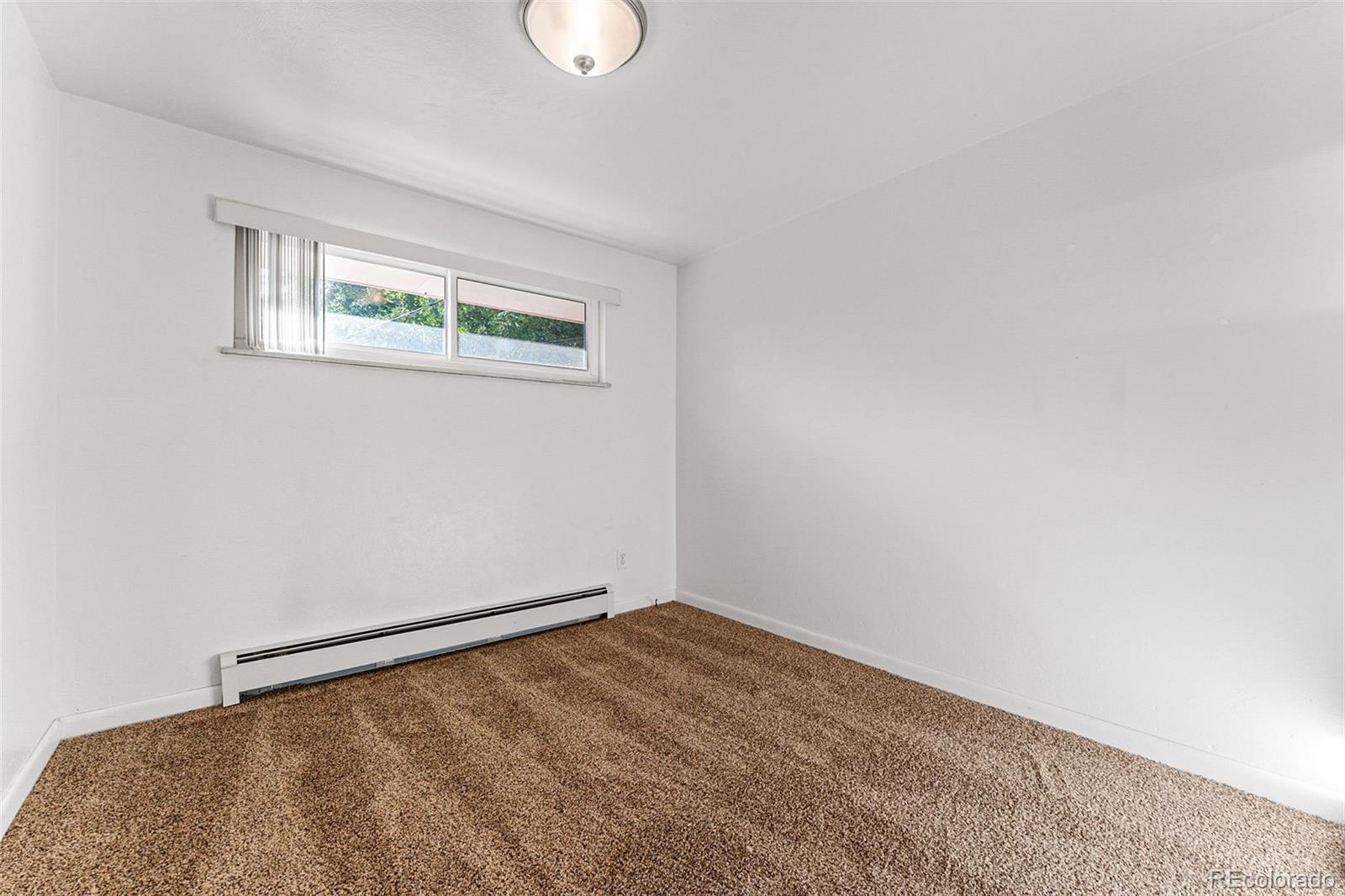3709 Allison Street Wheat Ridge, CO 80033 - Photo 34 of 44 a view of an empty room with a window