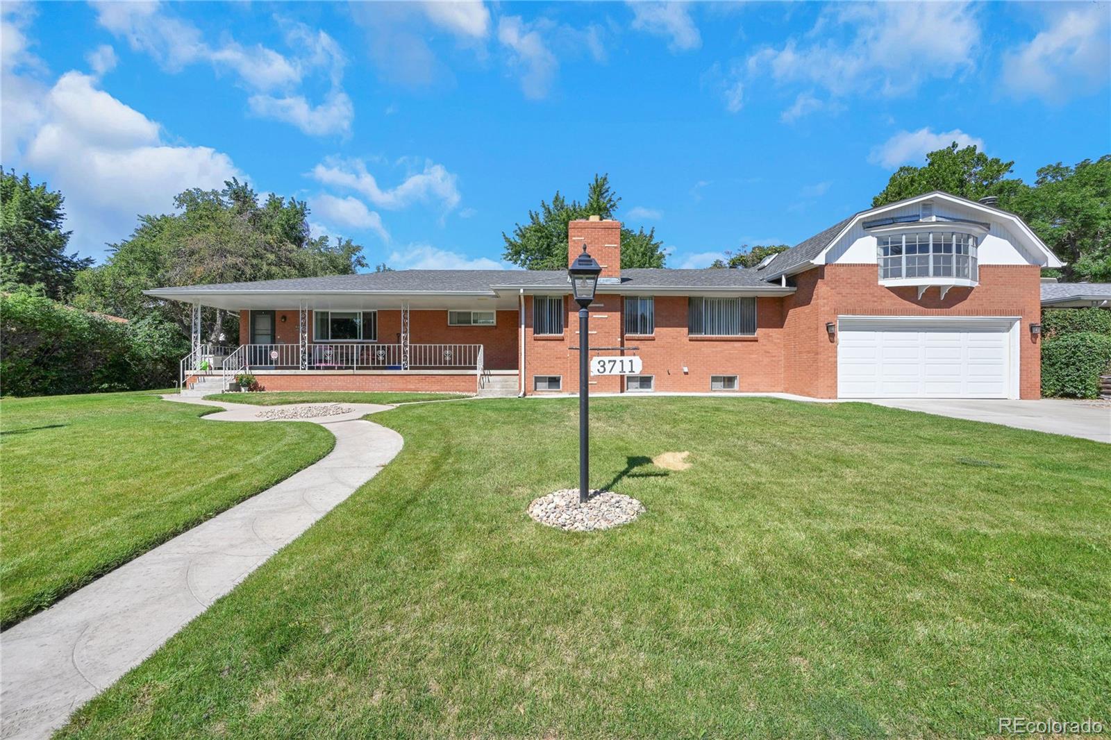 3709 Allison Street Wheat Ridge, CO 80033 - Photo 39 of 44 a front view of a house with a yard