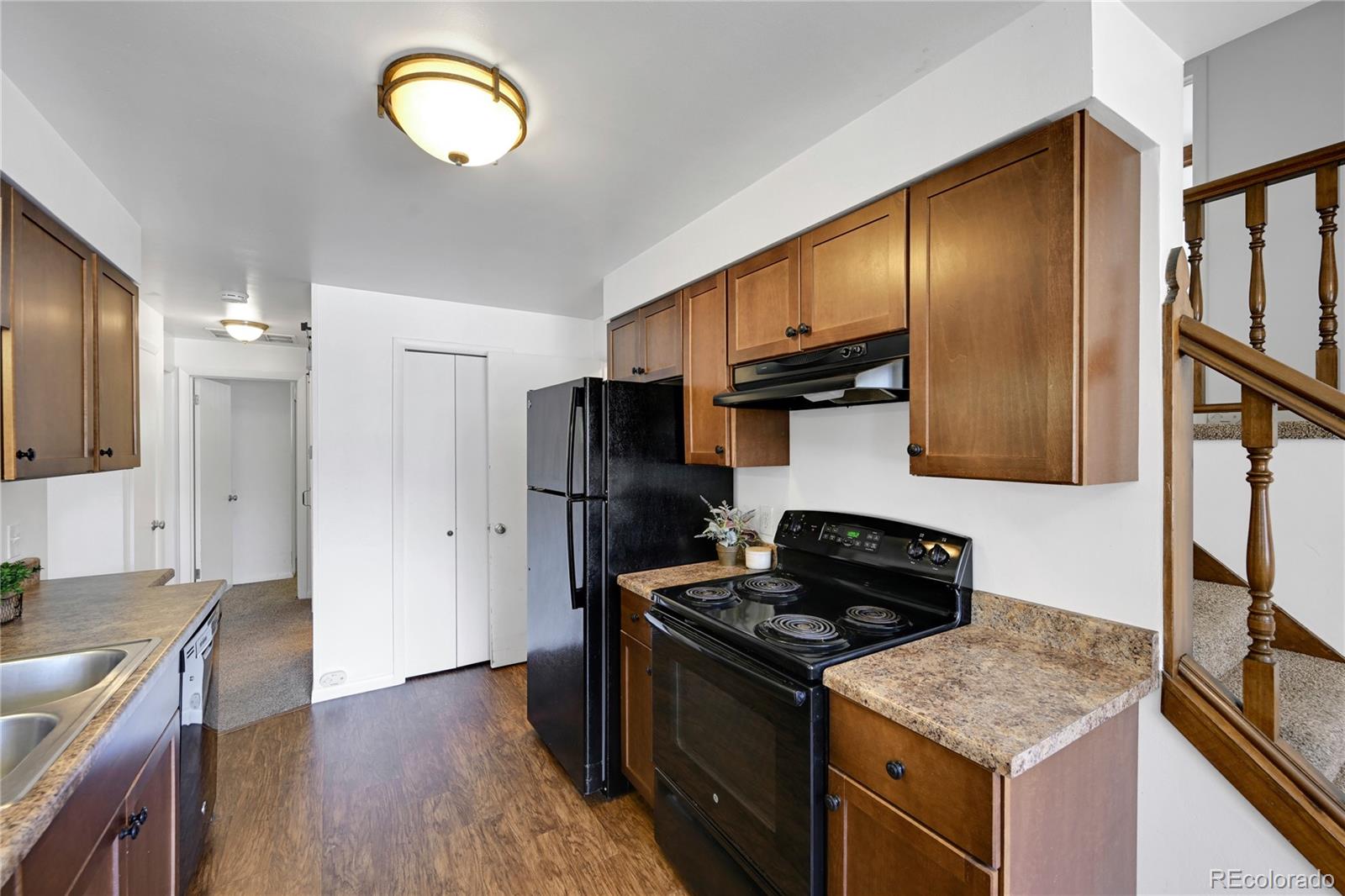 3709 Allison Street Wheat Ridge, CO 80033 - Photo 7 of 44 a kitchen with granite countertop a stove and a refrigerator