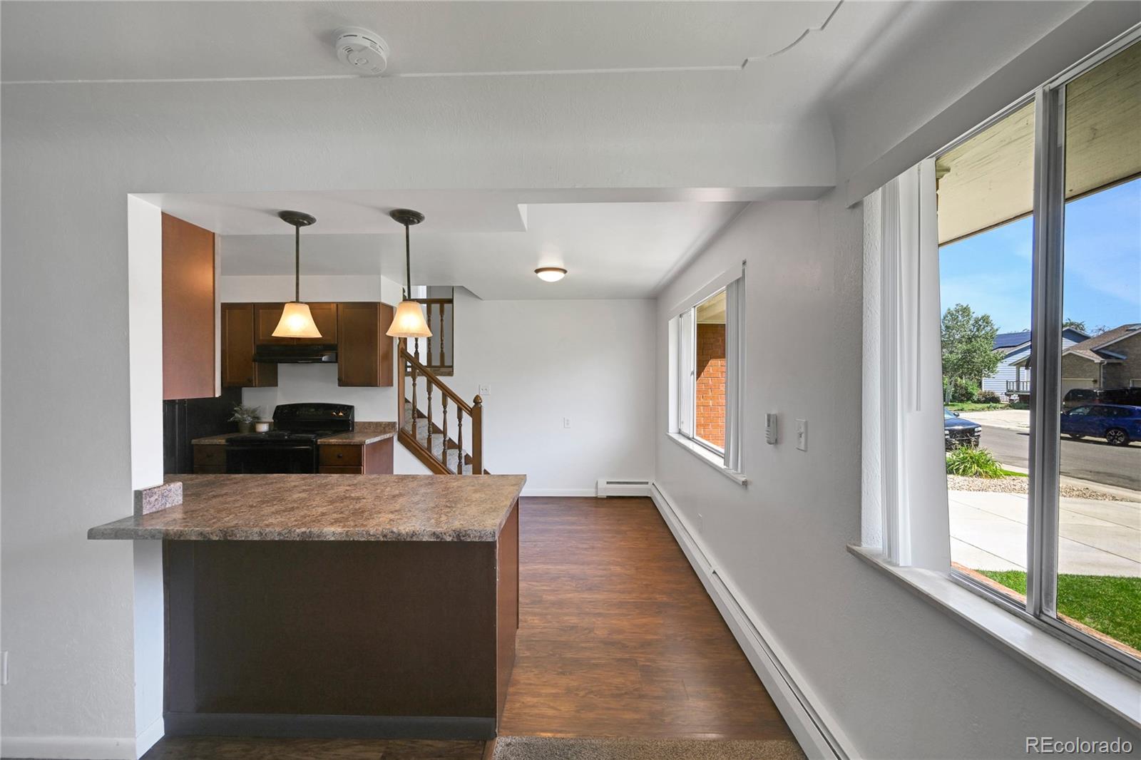 3709 Allison Street Wheat Ridge, CO 80033 - Photo 8 of 44 a kitchen view with wooden floor and outdoor view