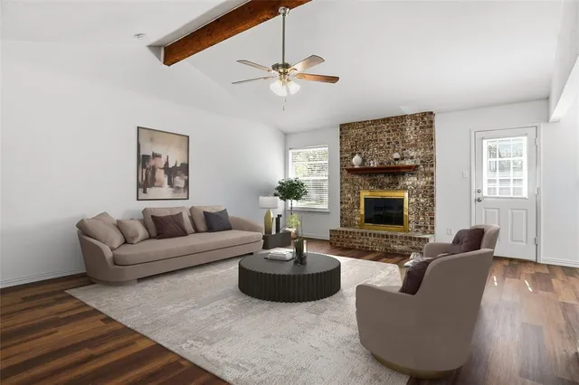 a living room with furniture a fireplace and a large mirror