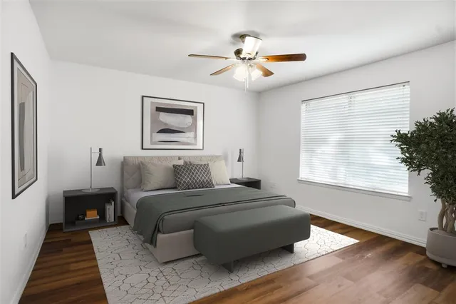 a bedroom with a large bed and a window