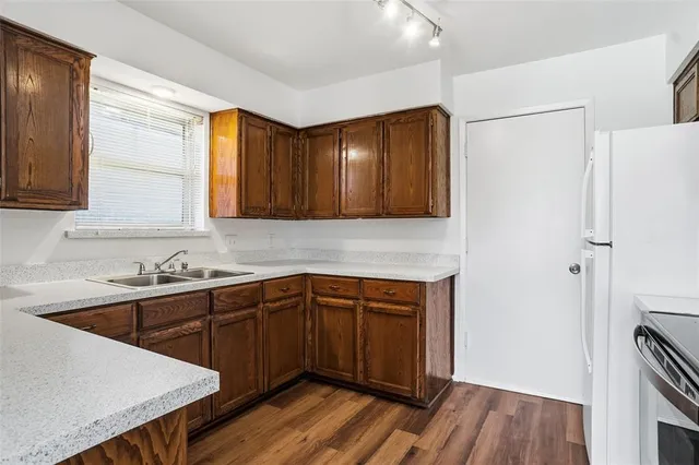 a kitchen with sink cabinets and wooden floor