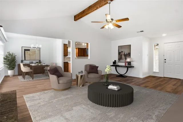 a living room with furniture and a chandelier