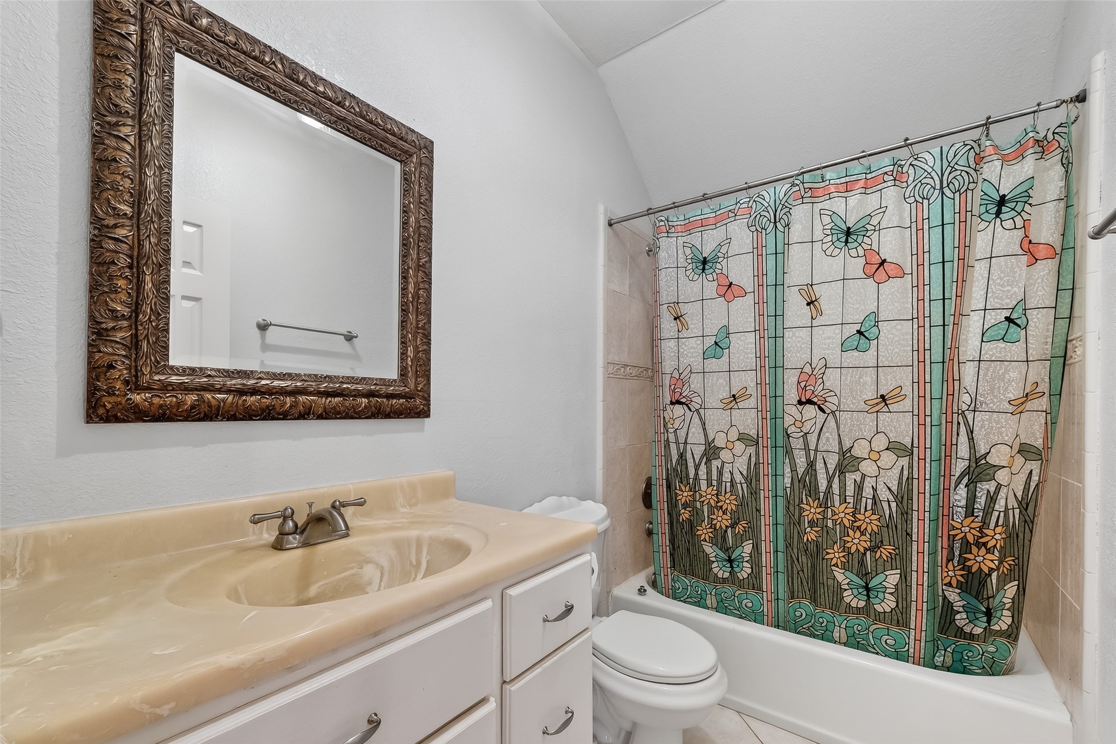 512 Bertloma Street Pasadena, TX 77502 - Photo 12 of 48 a bathroom with a sink a toilet and shower curtain