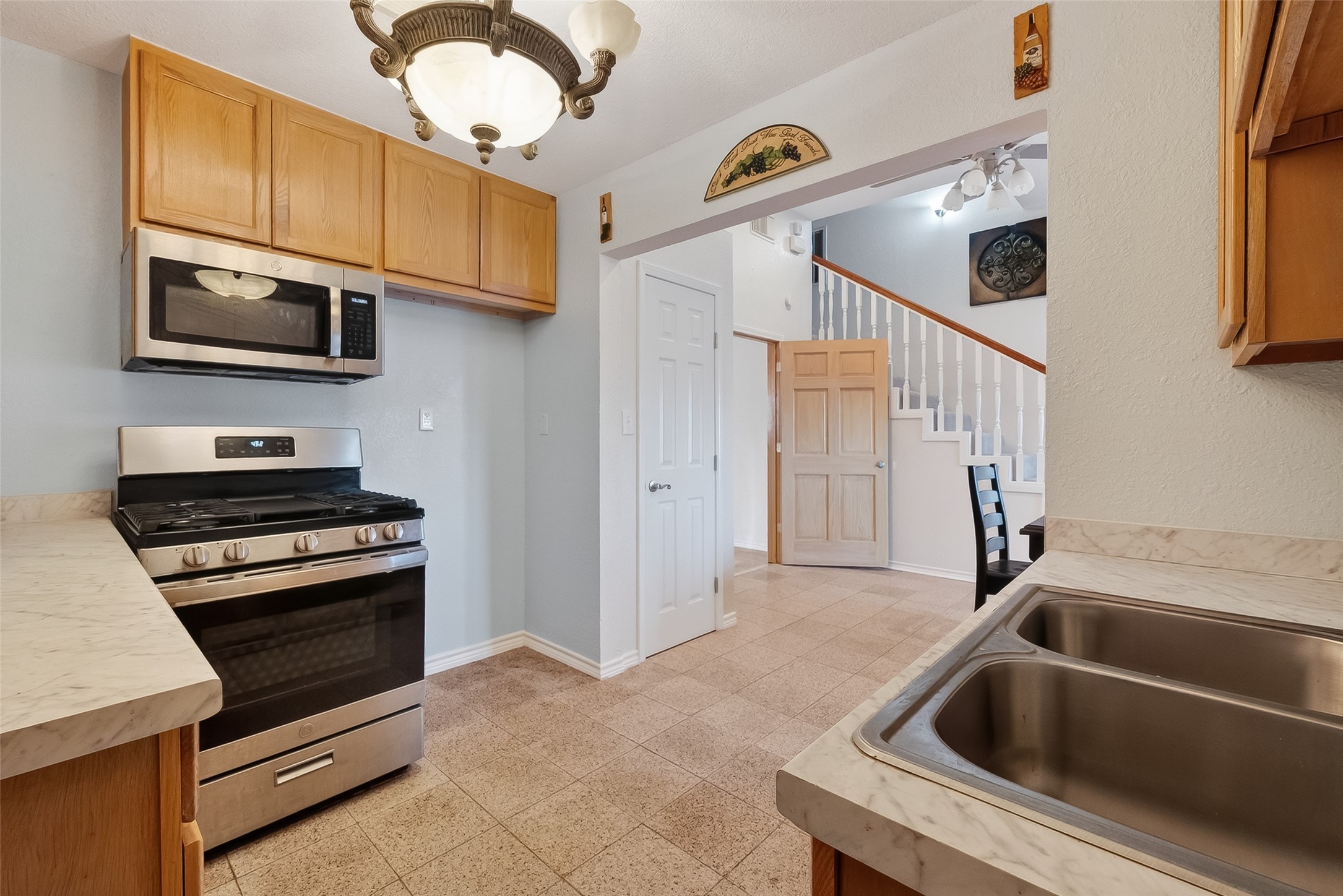 512 Bertloma Street Pasadena, TX 77502 - Photo 21 of 48 a kitchen with stainless steel appliances granite countertop a sink and a stove top oven