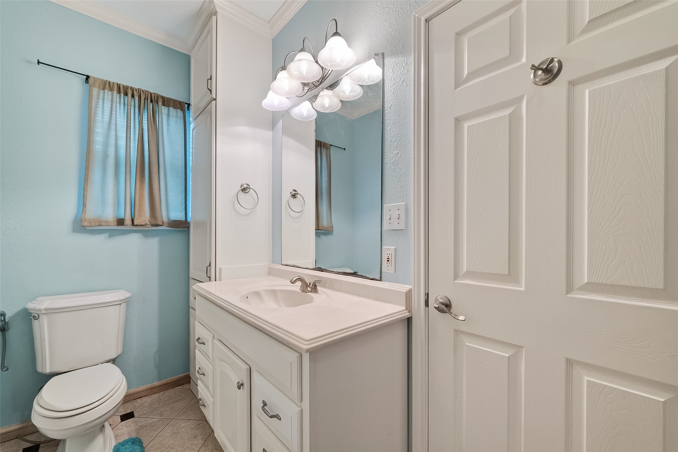 512 Bertloma Street Pasadena, TX 77502 - Photo 25 of 48 a bathroom with a sink a toilet and a mirror