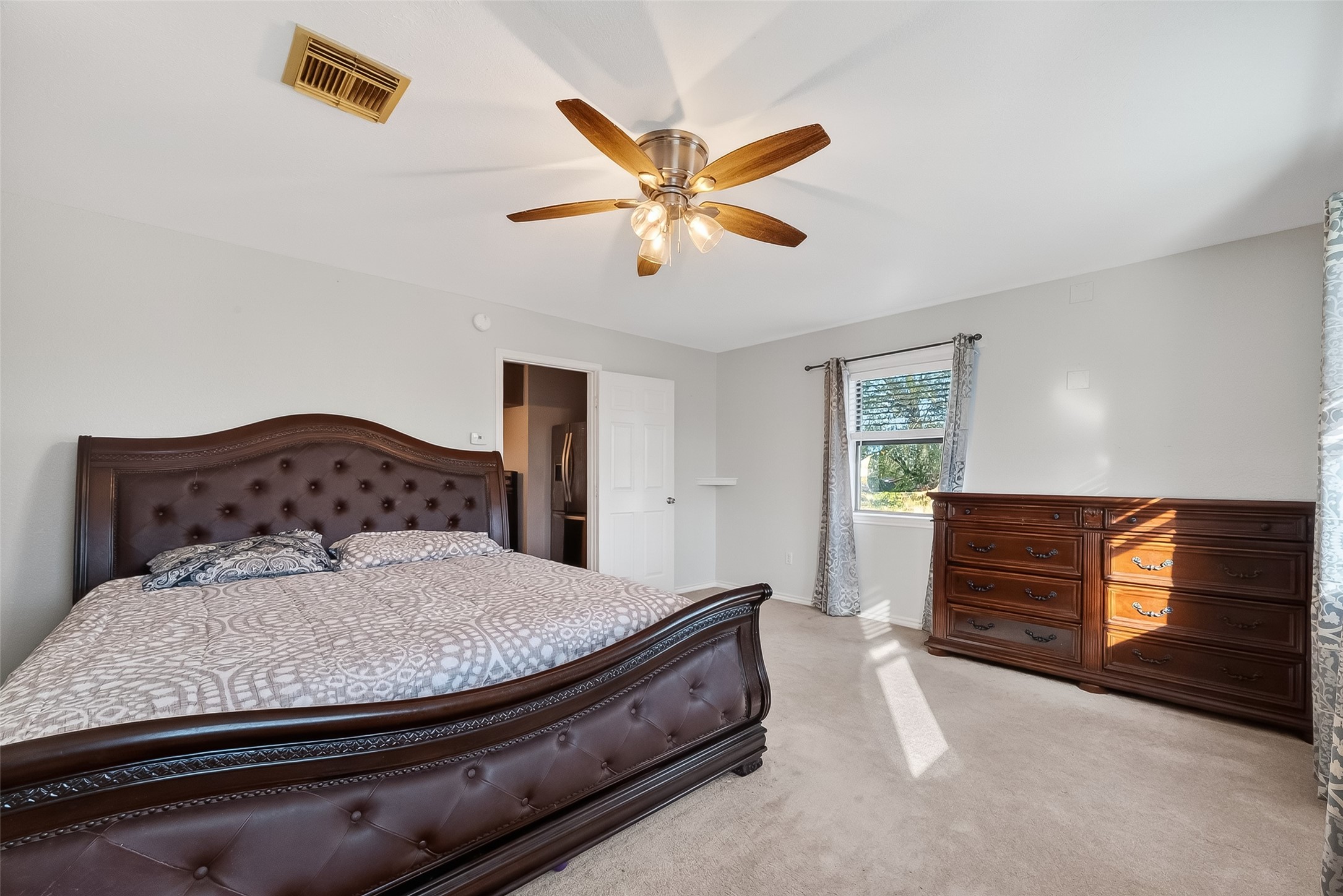 512 Bertloma Street Pasadena, TX 77502 - Photo 40 of 48 a bedroom with a bed and dresser with wooden floor