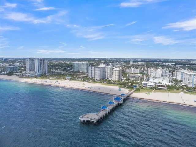 a view of a patio with table and chairs under an umbrella