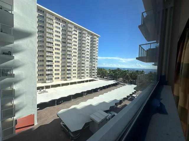 a spacious bedroom with a bed and a chair