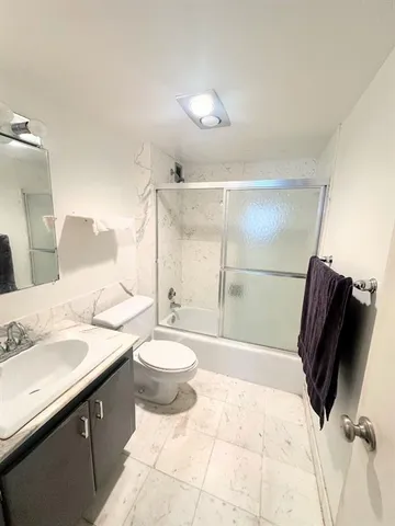 a lobby with entryway and a potted plant