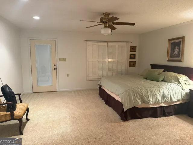 a bedroom with a bed and a chair