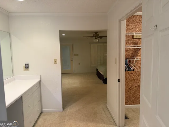 a bedroom with a bed and a ceiling fan