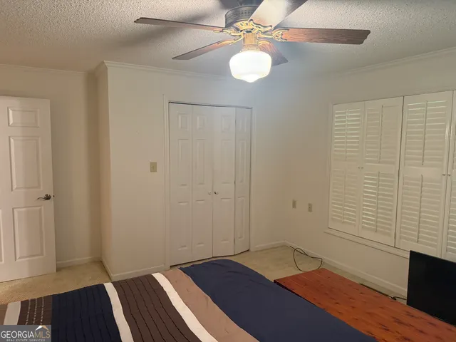 a bedroom with a bed and window