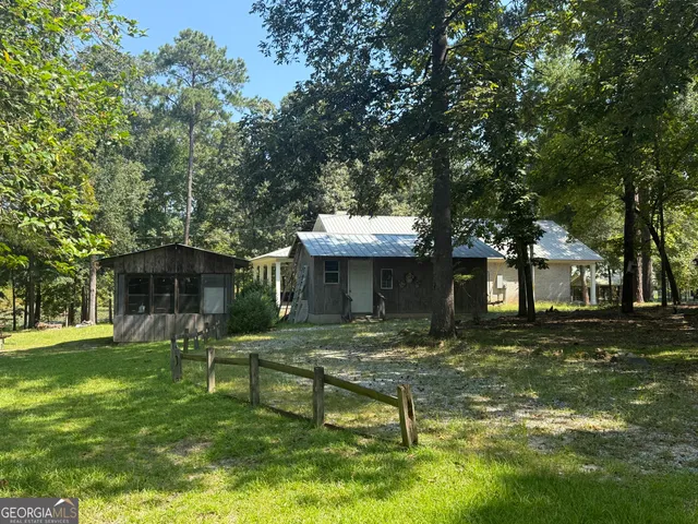 a view of a house with backyard and a patio