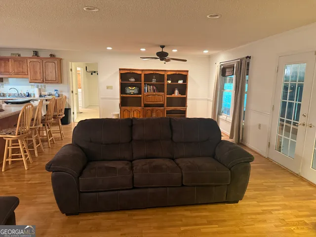 a living room with furniture and kitchen view