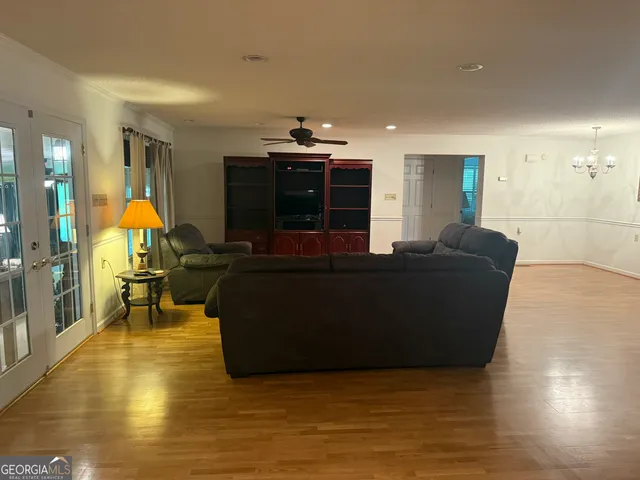 a living room with furniture and a wooden floor