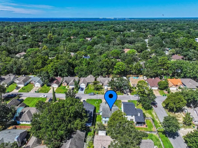 an aerial view of a house with swimming pool and lake view