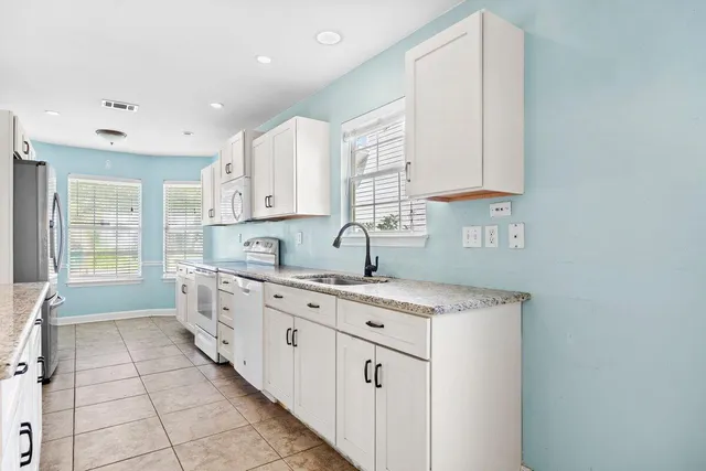a kitchen with a sink stove and cabinets