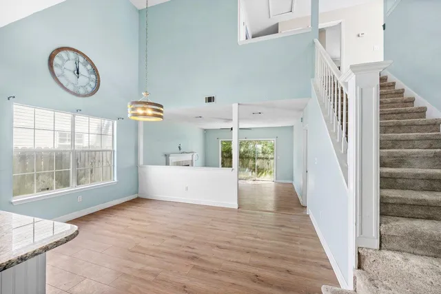 a view of a room with wooden floor and a window