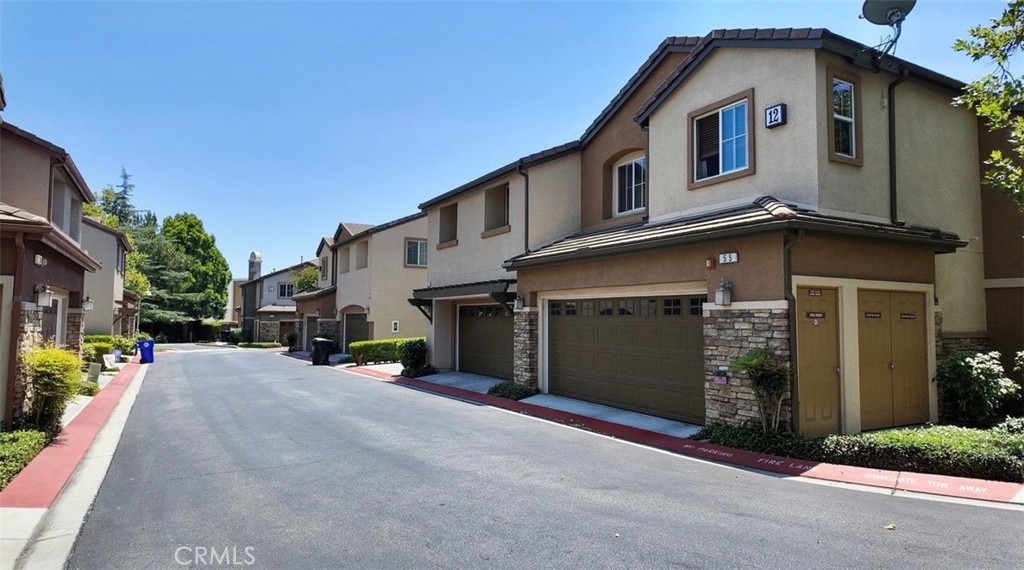 8692 East 9th Street, Unit 56 Rancho Cucamonga, CA 91730 - Photo 29 of 34 a front view of a house with a yard