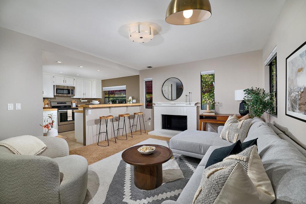11518 Madera Rosa Way San Diego, CA 92124 - Photo 10 of 42 a living room with furniture a fireplace and a window