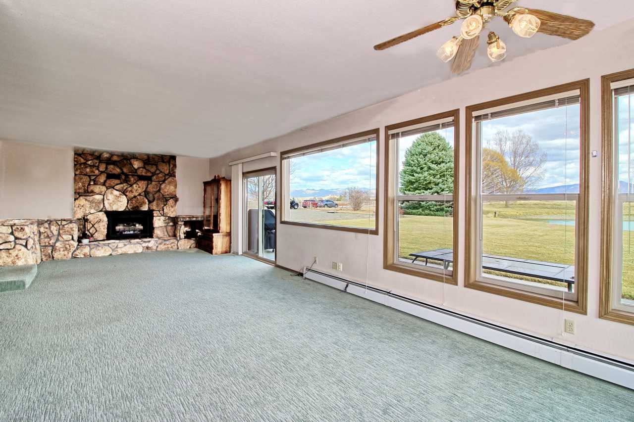 1420 18 Road Fruita, CO 81521 - Photo 25 of 42 a living room with furniture and a large window