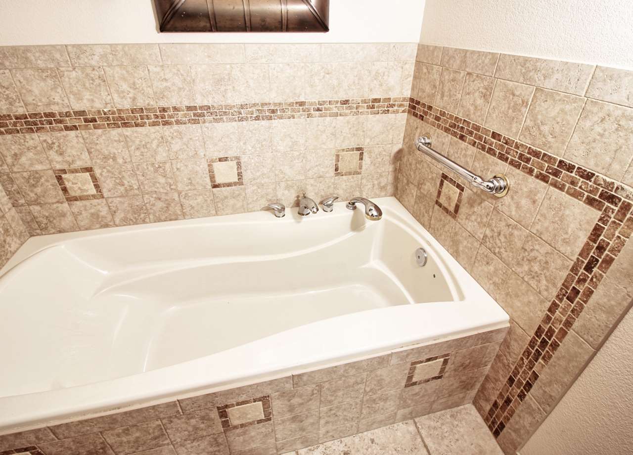 1420 18 Road Fruita, CO 81521 - Photo 29 of 42 a bathroom with a bathtub and shower