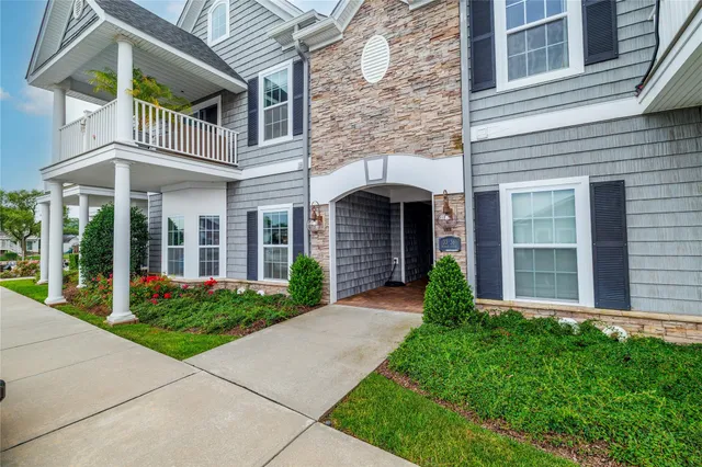 a front view of a brick house with a yard