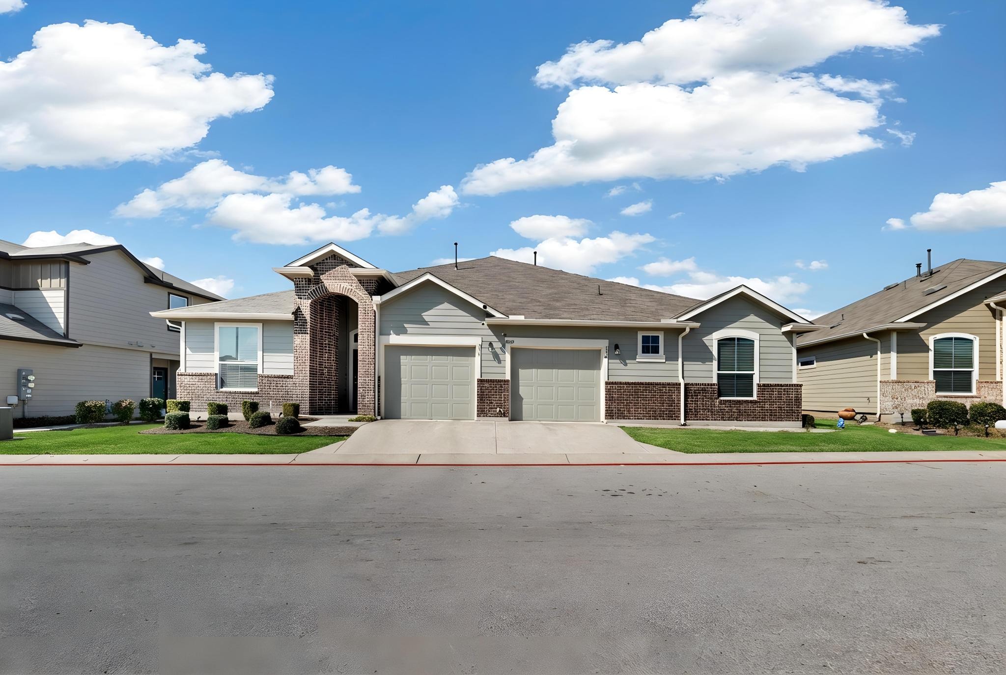 14409 Frankel Loop, Unit 33A Pflugerville, TX 78660 - Photo 3 of 28 a front view of a house with a yard and garage
