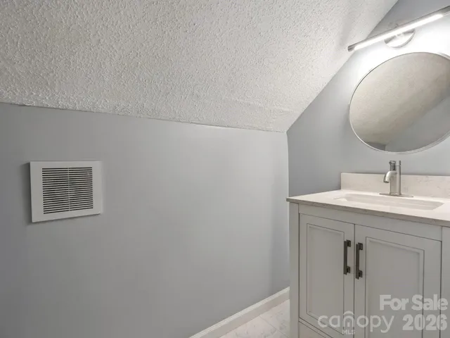 a bathroom with a sink and mirror