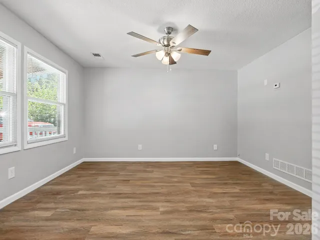 a view of wooden floor and windows in a room