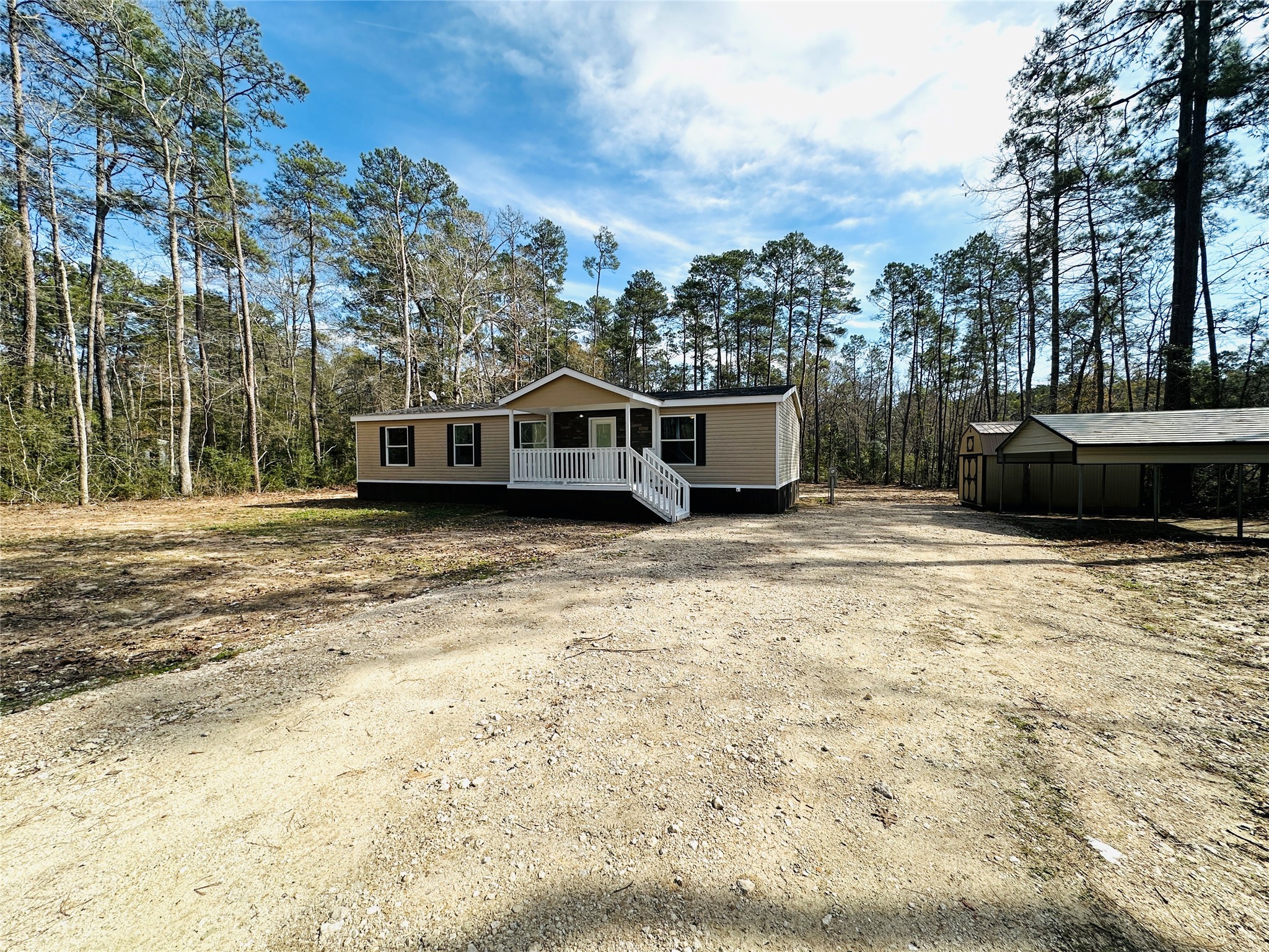 a view of a house with a yard and trees
