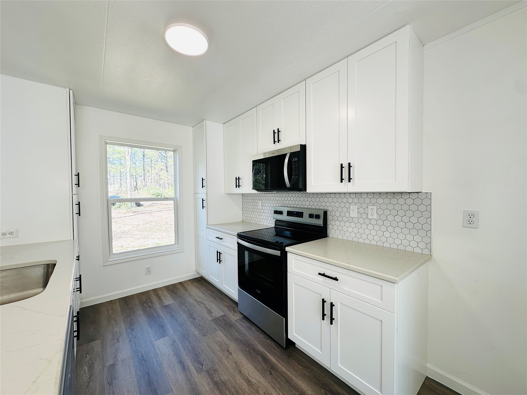 11269 Newton Circle Conroe, TX 77303 - Photo 11 of 39 a kitchen with white cabinets and white appliances
