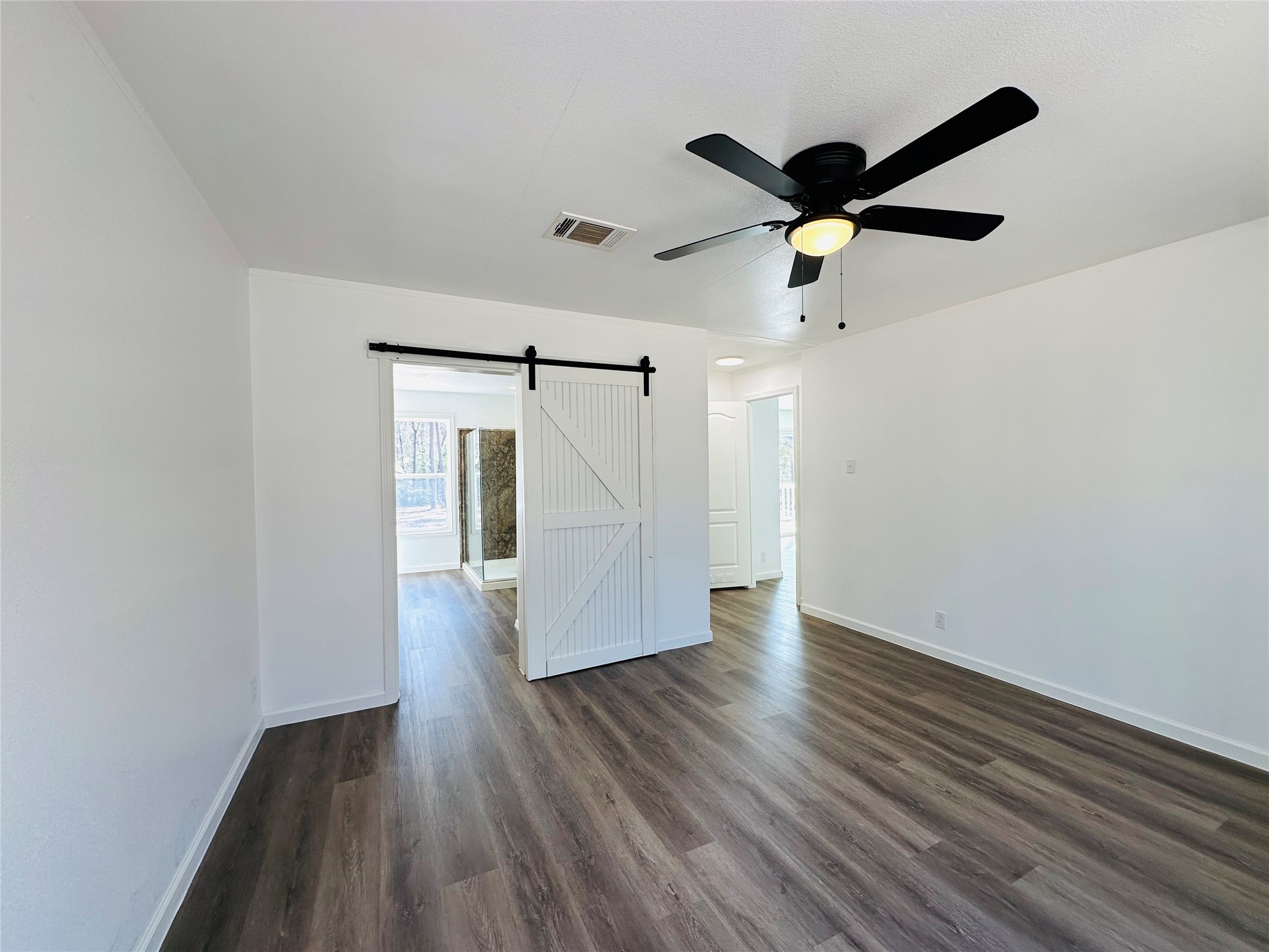 11269 Newton Circle Conroe, TX 77303 - Photo 14 of 39 a view of an empty room with wooden floor and a ceiling fan