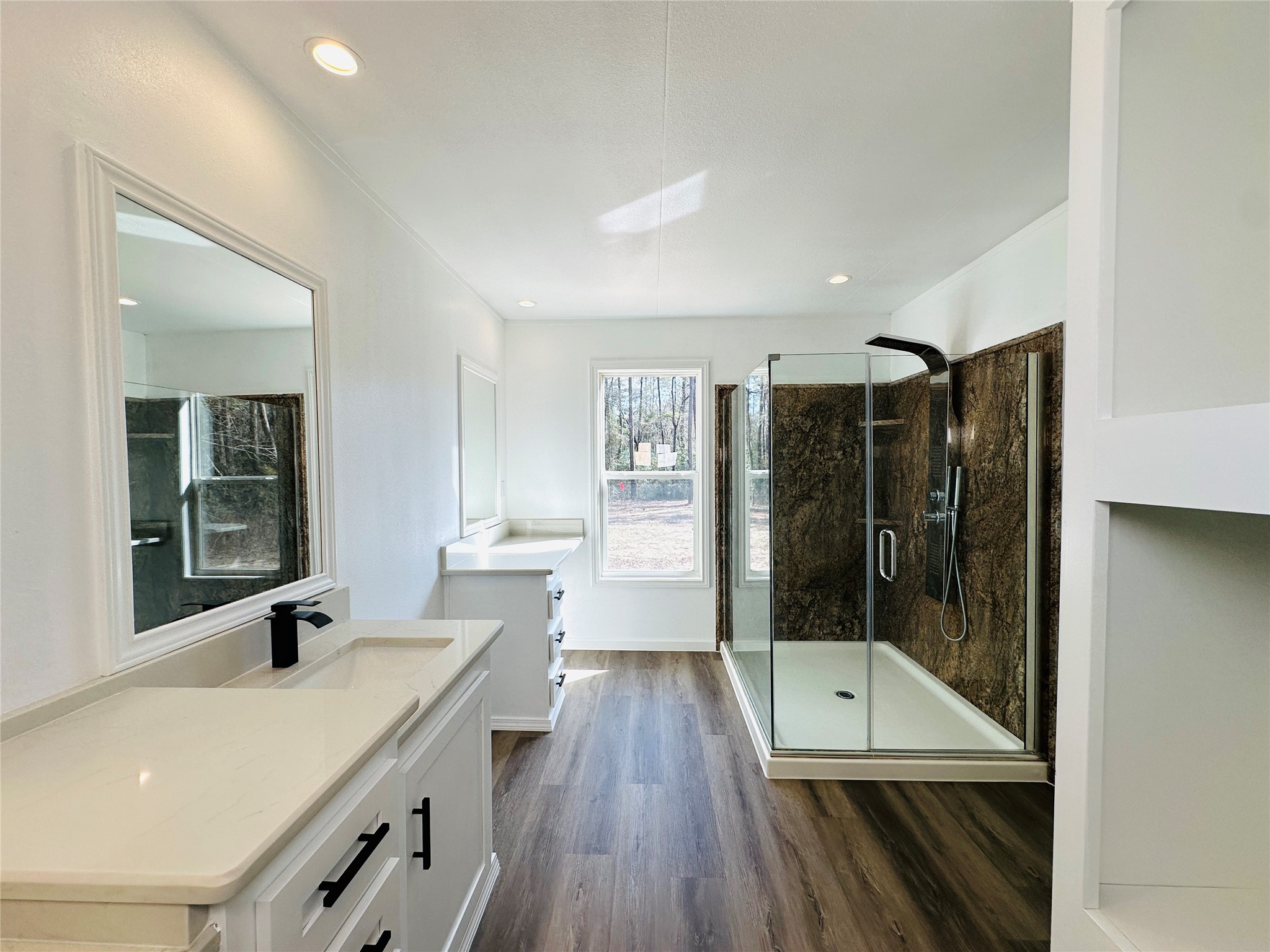 11269 Newton Circle Conroe, TX 77303 - Photo 15 of 39 a bathroom with a granite countertop sink a mirror and shower