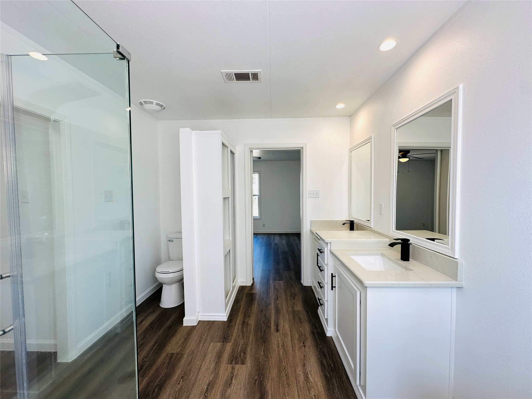 11269 Newton Circle Conroe, TX 77303 - Photo 17 of 39 a bathroom with a double vanity sink a mirror and a shower